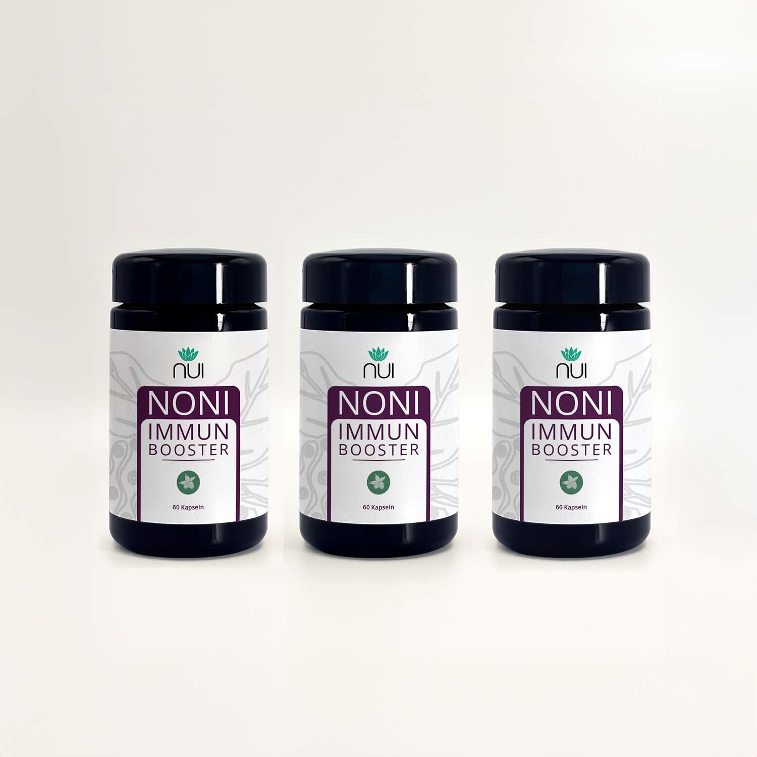 NUI NONI Immunbooster: drei Kapselgläser nebeneinander vor hellem Hintergrund
