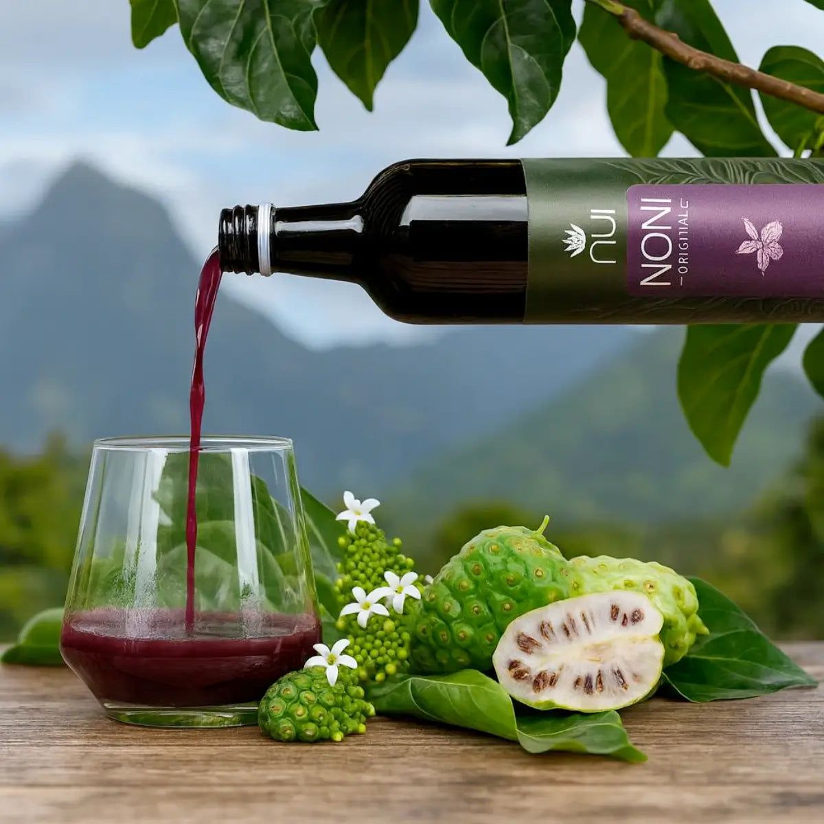 NUI NONI Original wird in ein Glas gegossen, daneben frische Noni-Früchte